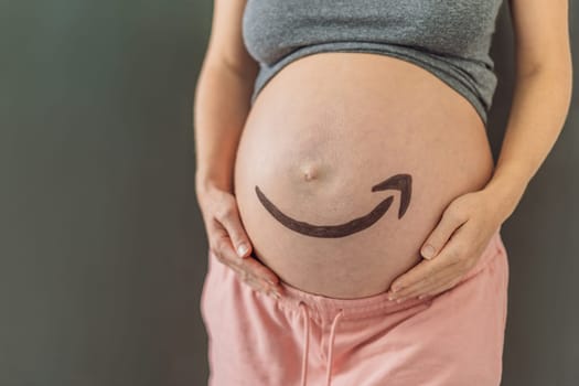 28.01.23, Mexico, Playa del Carmen: Creative concept of an Amazon icon on a pregnant belly, symbolizing the anticipation and delivery of joy, much like the reliable and timely services provided by Amazon. As well as products for pregnant women and babies on Amazon.