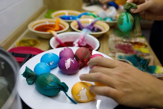 painted eggs with different colors on a plate. High quality photo