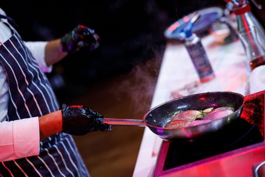 oysters in a frying pan cooks the chef, fire. High quality photo