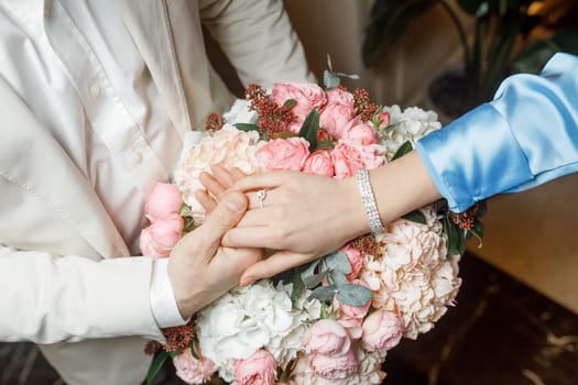 hands of lovers on a bouquet. High quality photo