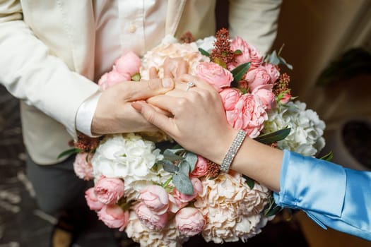 hands of lovers on a bouquet. High quality photo