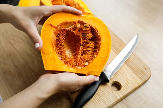 cut pumpkin many grains knife board hands. High quality photo