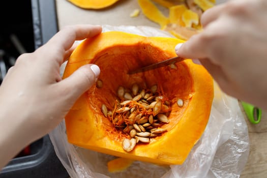 cut pumpkin many grains knife board hands. High quality photo