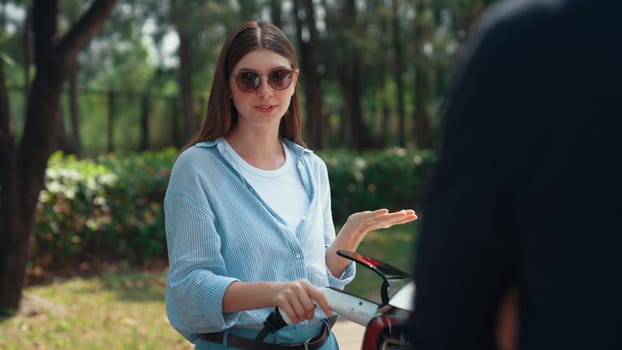 EV car recharging electricity for battery by lovey couple traveling during their road trip travel by eco friendly electric vehicle in national park and greenery forest on holiday. Exalt