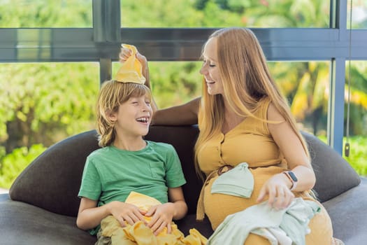 Heartwarming family moment as expectant mom and son joyfully browse through newborn baby's clothes, eagerly anticipating the arrival of a new family member.