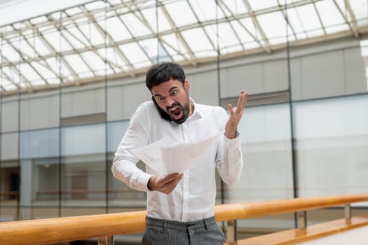 Confident handsome businessman standing in the office. High quality photo