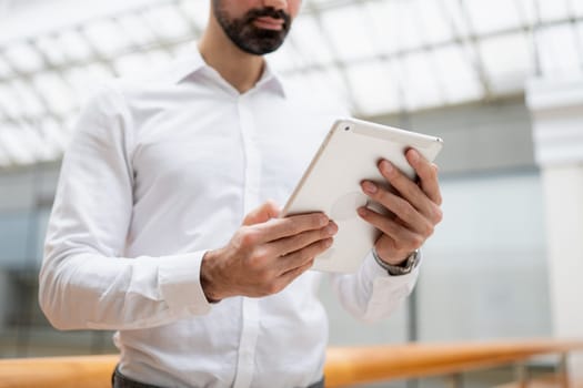 Confident handsome businessman standing in the office. High quality photo