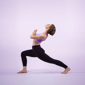 Full body length gaiety shot athletic and sporty woman doing healthy and meditative yoga exercise workout posture on isolated background. Healthy active and body care lifestyle