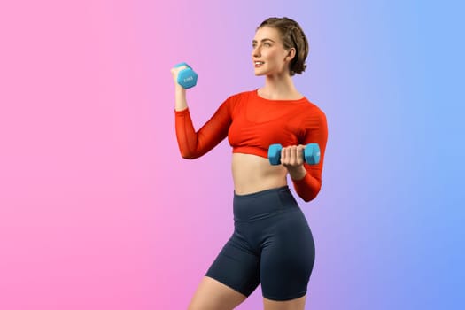 Full body length gaiety shot athletic and sporty woman with dumbbell for weight lifting as bodybuilding exercise in standing posture on isolated background. Healthy active and body care lifestyle