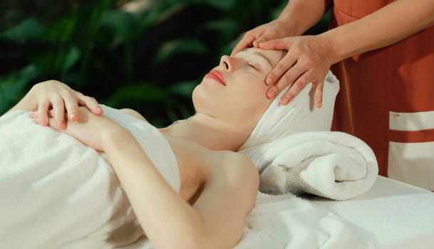 Attractive caucasian woman receive electrical facial treatment. Beautiful girl lies on spa bed while having medical treatment from professional doctor from medical spa center. Tranquility.