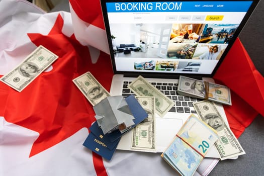 travel laptop, money and Canadian flag.