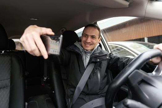 Joyful indian man driving car, shot from dashboard, going on trip during summer vacation, copy space. Happy middle-eastern guy in casual outfit and glasses driving his brand new nice car. High quality photo