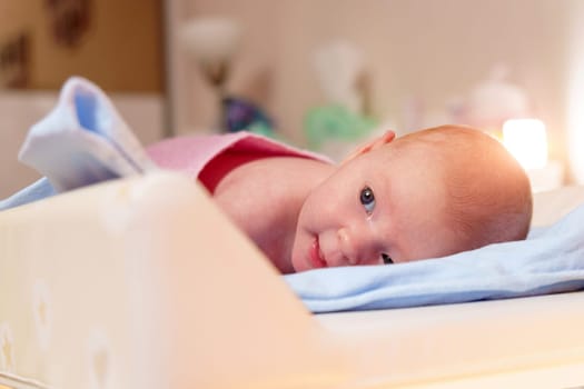 Early life, this close-up portrait reveals the tranquil beauty of a 2-month-old baby