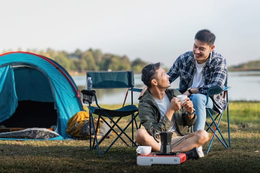 Happy Asian male gay couple on camping together in a forest. romantic vocation trip. lgbt concept.