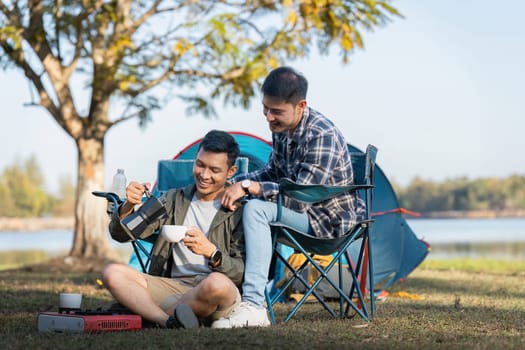 Happy Asian male gay couple on camping together in a forest. romantic vocation trip. lgbt concept.