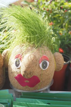 Handmade doll for growing grass seeds as hairs. Child education.