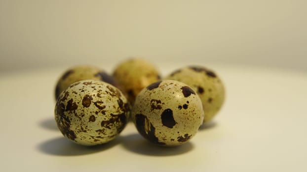 Spotted quail eggs on a light background, natural eco-friendly products