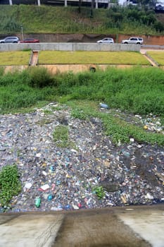 salvador, bahia, brazil - september 12, 2023: view of a river channel with lots of dirt and pollution in the city of Salvador.