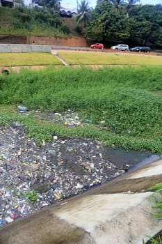 salvador, bahia, brazil - september 12, 2023: view of a river channel with lots of dirt and pollution in the city of Salvador.