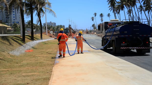 salvador, bahia, brazil - november 20, 2024: workers working on the Atlantic coast of the city of Salvador.