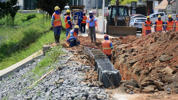 lauro de freitas, bahia, brazil - august 30, 2024: repair work on a canal on the river Ipitanga in the city of Lauro de Freitas.