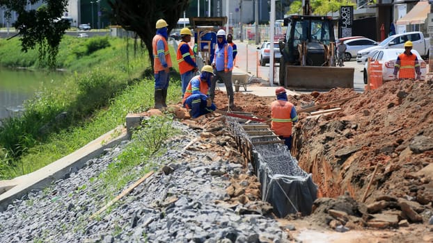 lauro de freitas, bahia, brazil - august 30, 2024: repair work on a canal on the river Ipitanga in the city of Lauro de Freitas.