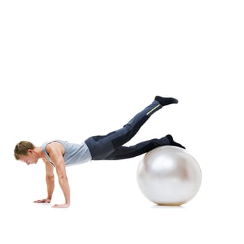 Yoga ball, fitness and man in a studio with a body, health and wellness exercise for balance. Sports, equipment and young male athlete with stretching workout or training isolated by white background.