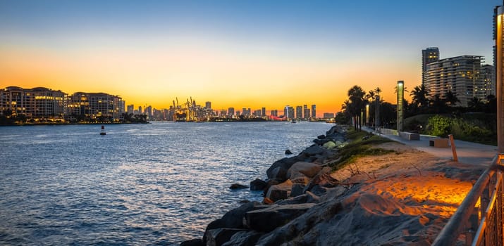 Miami beach walkway and Miami skyline sunset panoramic view, Florida, United States of America