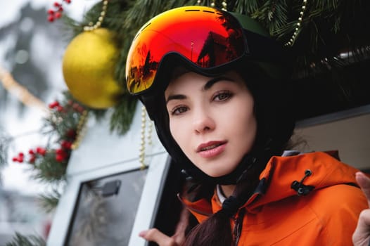 Portrait of a woman in the Alps. Young beautiful caucasian woman in ski goggles looking at the camera with a sexy look.