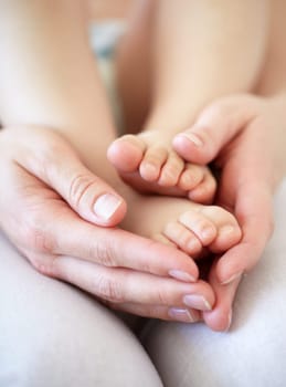 Love, person and hands with newborn or feet for development, nurture and bonding in nursery of apartment. Family, parent and baby toes with trust, support or care for relationship or closeup in home.