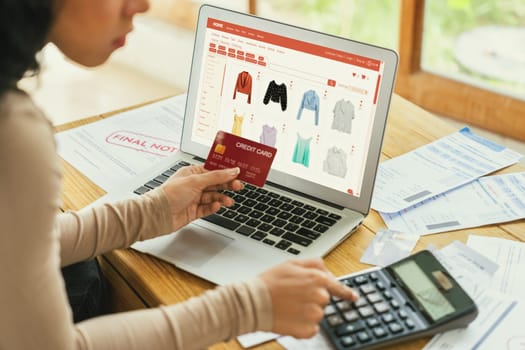 Woman shopping online on internet marketplace browsing for sale items for modern lifestyle and use credit card for online payment from wallet protected by crucial cyber security software