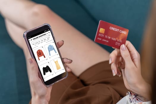 Woman shopping online on internet marketplace browsing for sale items for modern lifestyle and use credit card for online payment from wallet protected by utmost cyber security software