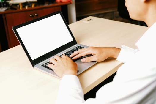 Business person or office worker using laptop computer while sitting at desk. uds