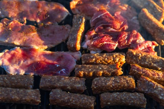 Grilling  pork chops on barbecue grill. BBQ in the garden