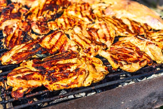 Chicken and pork steak grilled on a charcoal barbeque. Top view of camping tasty barbecue, food concept, food on grill and detail of food on the grill