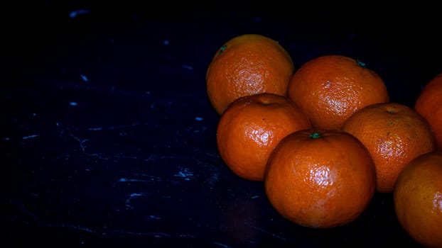 Detail of orange fruit on black background