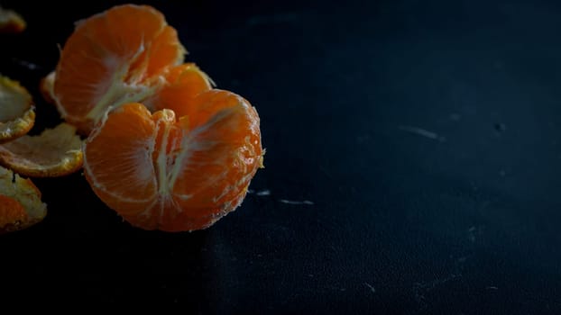 Sliced oranges on black background. Fresh fruit isolated on black