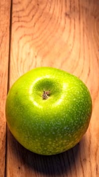 Tasty organic green juicy green apples on a rustic wooden background