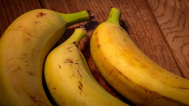 Fresh ripe bananas on a wooden board.