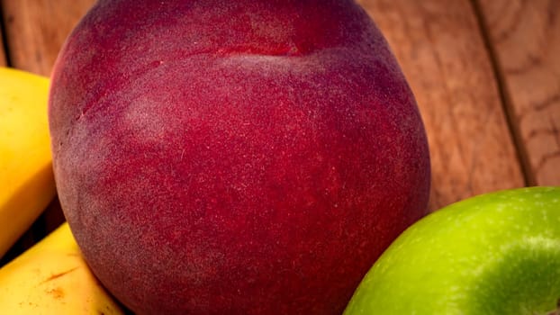 Mix of fresh fruits on wooden table