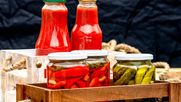 Bottles of tomato sauce, preserved canned pickled food concept isolated in a rustic composition.