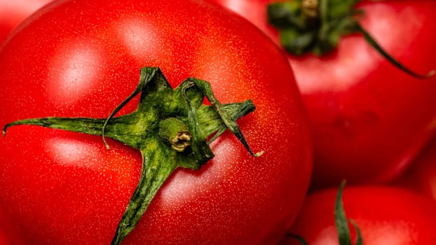 Close up of ripe red tomato, tomatoes background.