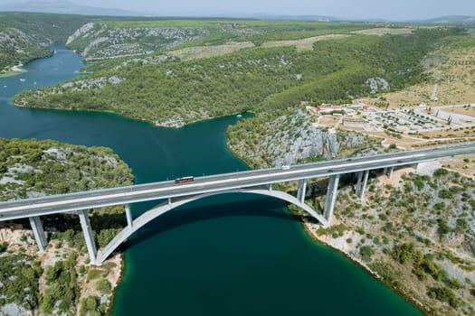 Bridge provides convenient passage for ships and boats to cross sea. Transport bridge across sea. Croatia's coastal charm is enhanced by presence of elegant bridges over sea.