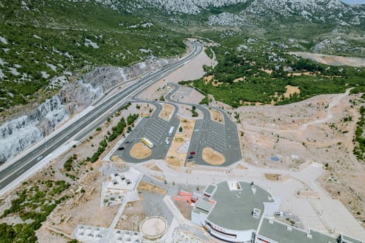 Parking lot at the foot of the mountains was bustling with tourists eager to begin their outdoor adventures.