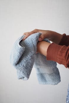 girl drying her hands in a white towel