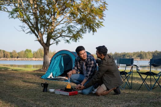 Happy Asian male gay couple on camping together in a forest. romantic vocation trip. lgbt concept.