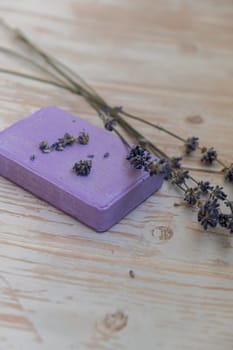 Handcrafted purple lavender soap with lavender flowers. Natural hydrating moisturiser softness cosmetic. Organic calming beauty skincare product. Herbal self care wellness alternative soap. Copy space