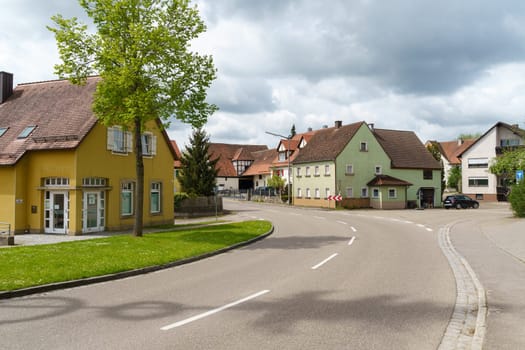 Weinberg, Germany - May 6, 2023: Houses along the road, cars in a German village.