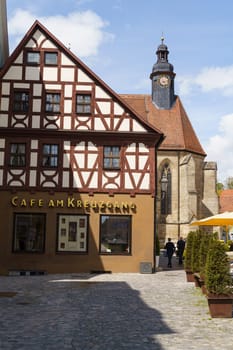 Feuchtwangen, Germany - May 6, 2023: Evangelical church behind the cafe building.