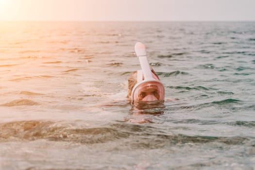 Young happy woman in white bikini put pink snorkeling mask on beach before swimming. girl having fun relaxing on beautiful beach. Beach lifestyle